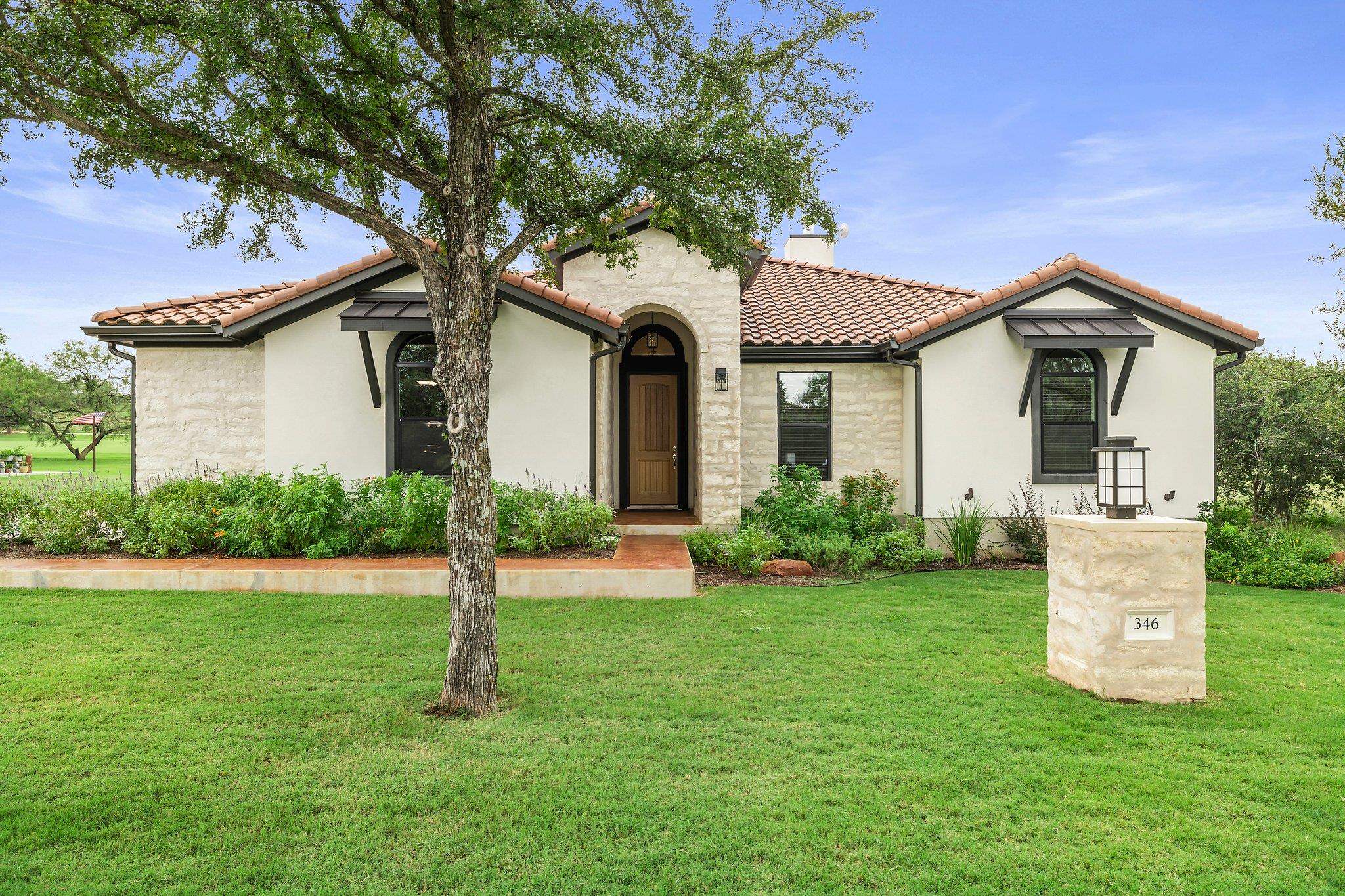 a front view of a house with a yard