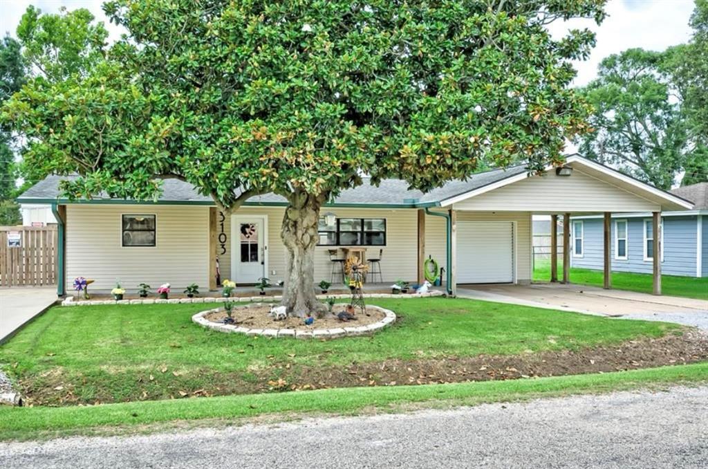 a front view of house with a garden and patio