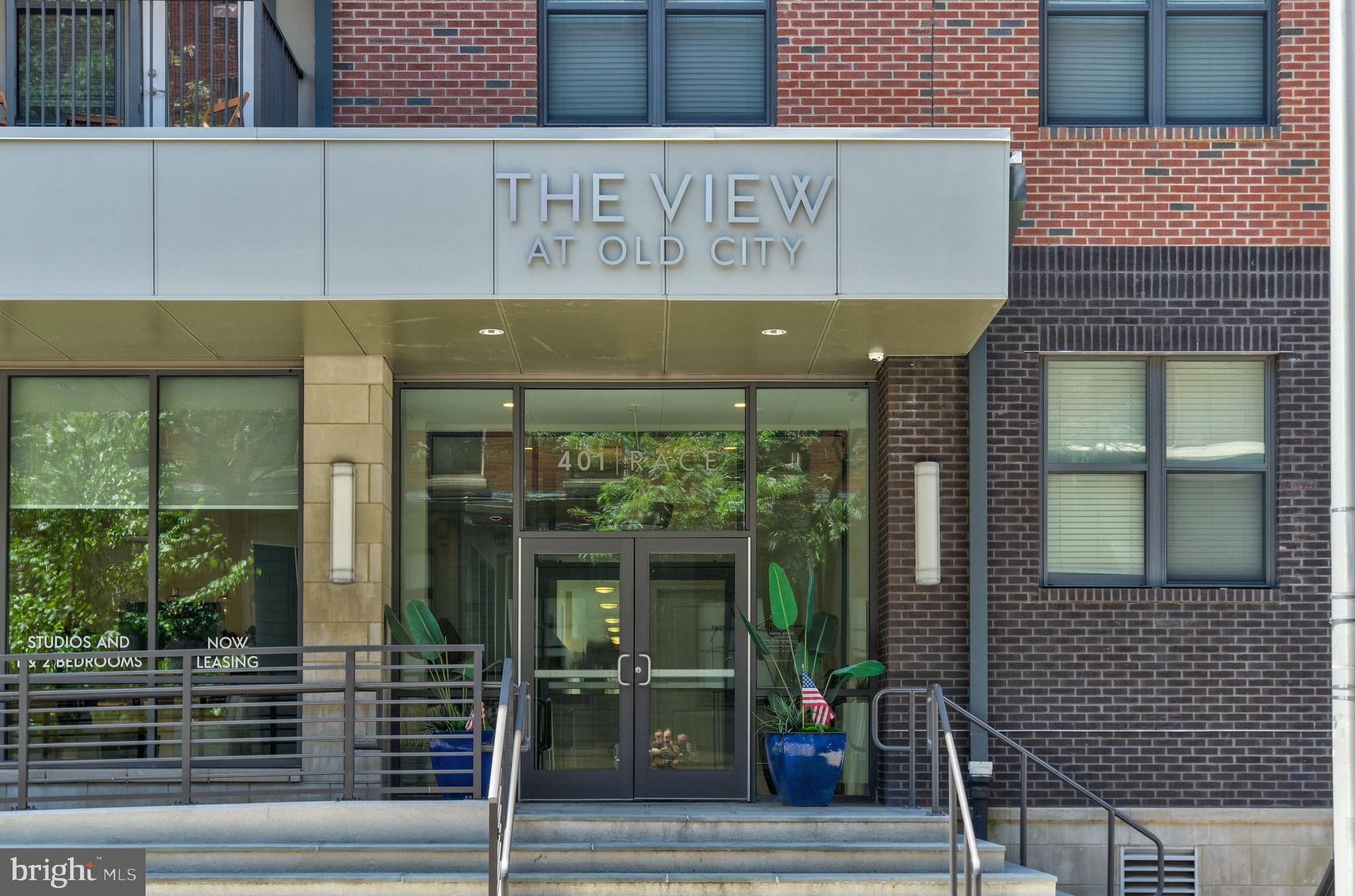 a front view of a building with glass windows and door