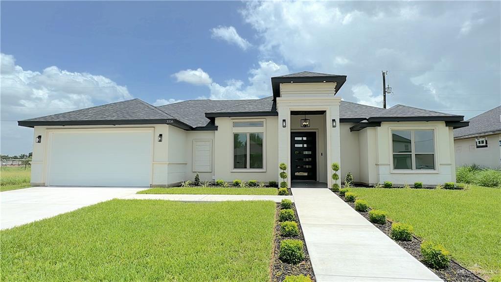 a front view of a house with a yard and garage