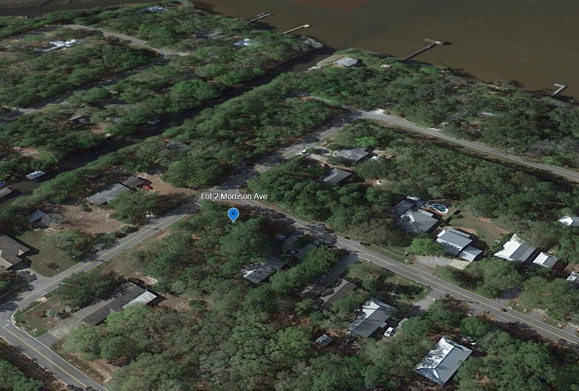 an aerial view of residential house with outdoor space and trees all around