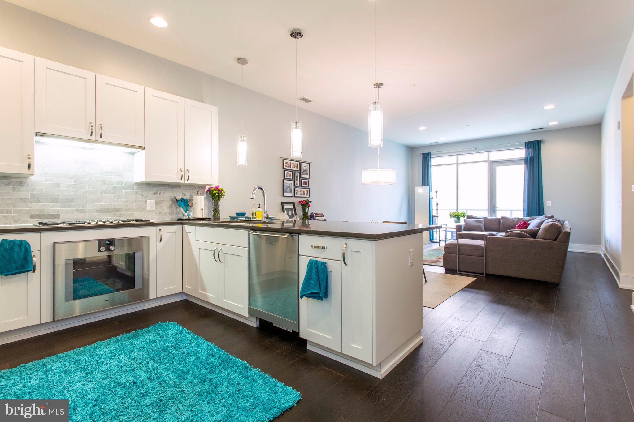 a kitchen with a sink a stove and cabinets