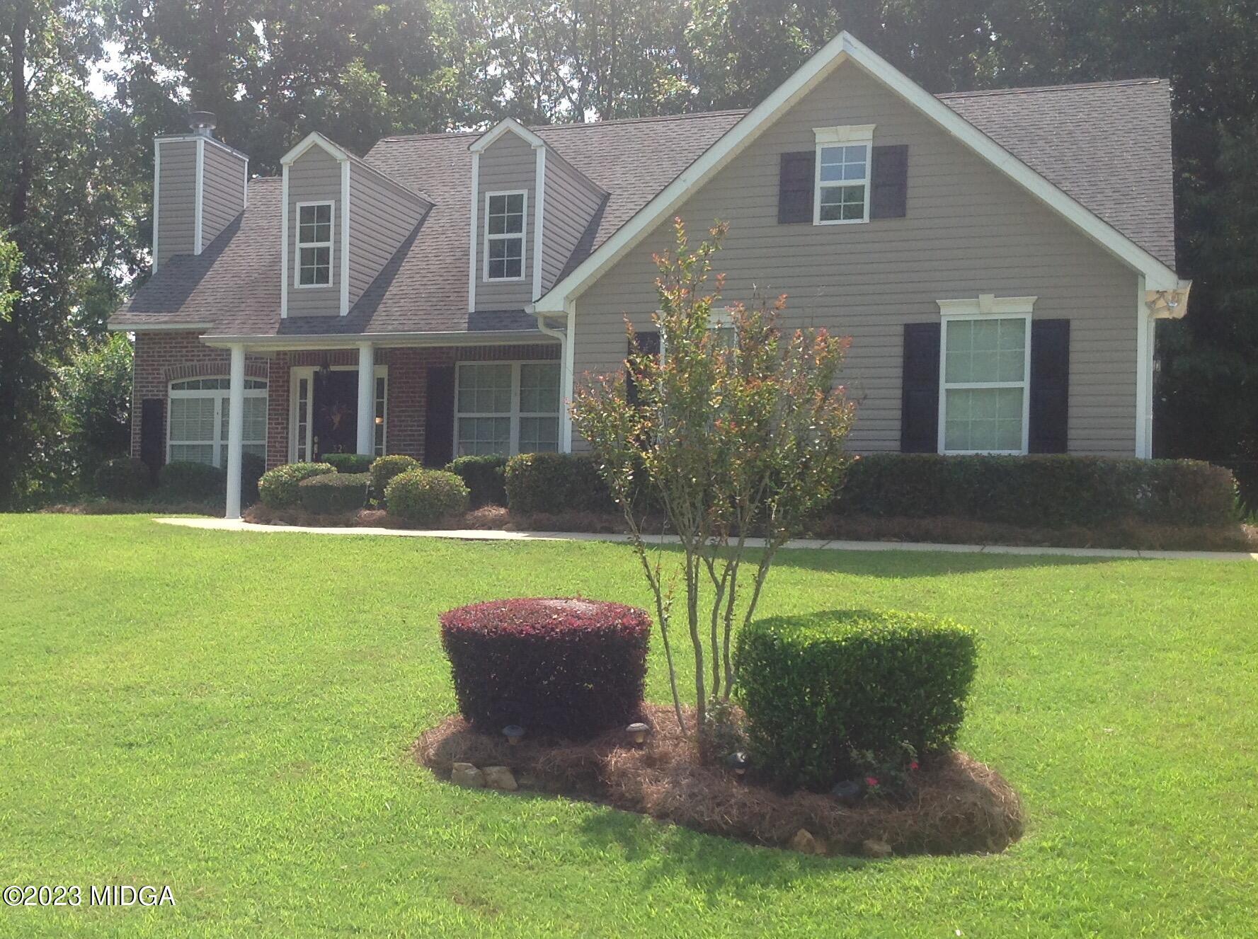 a front view of a house with garden