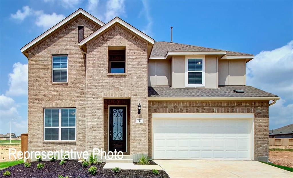 a front view of a house with garage