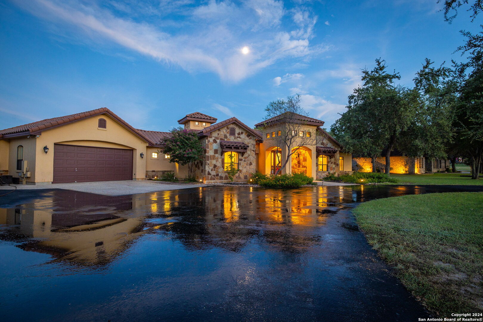 a front view of house with yard and lake view