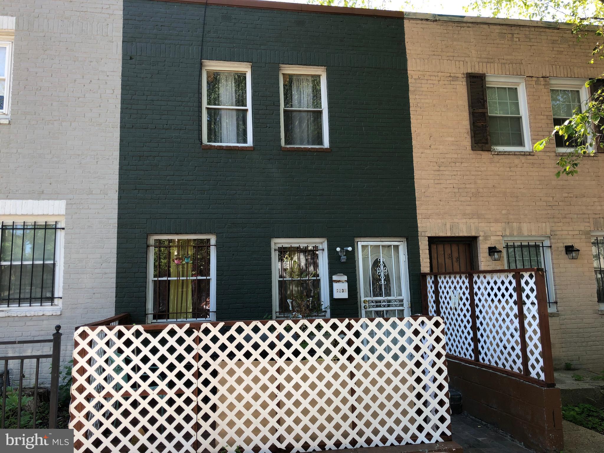 a couple of chairs sitting in front of a house