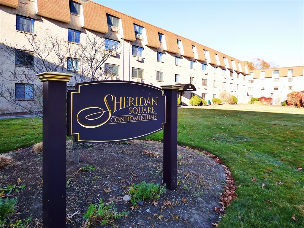 a sign broad in front of a brick building