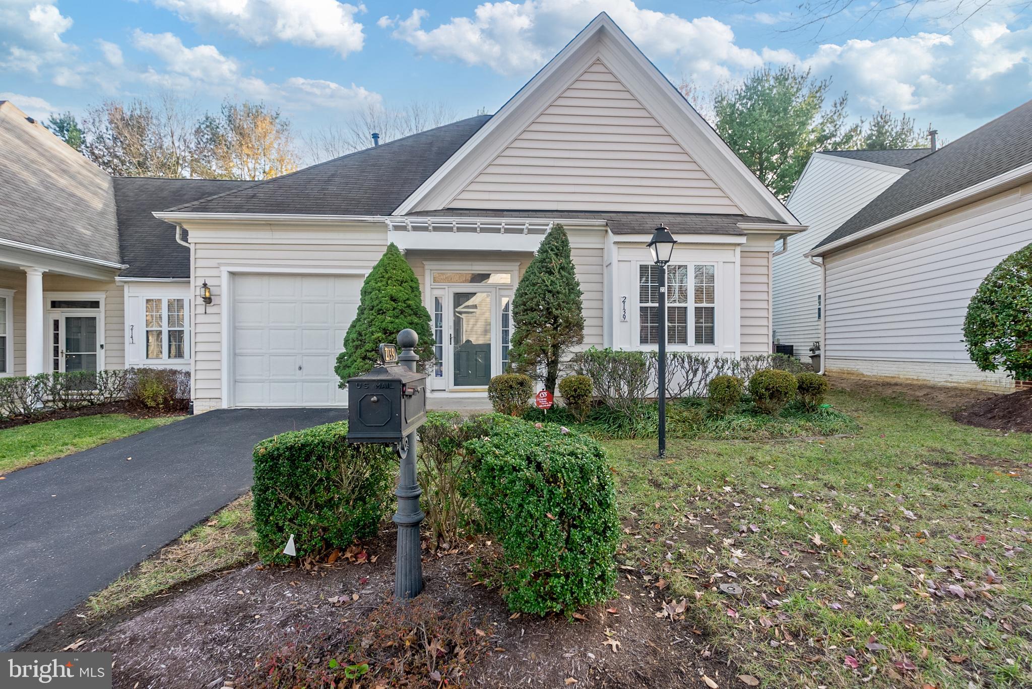 a front view of a house with a yard and outdoor seating