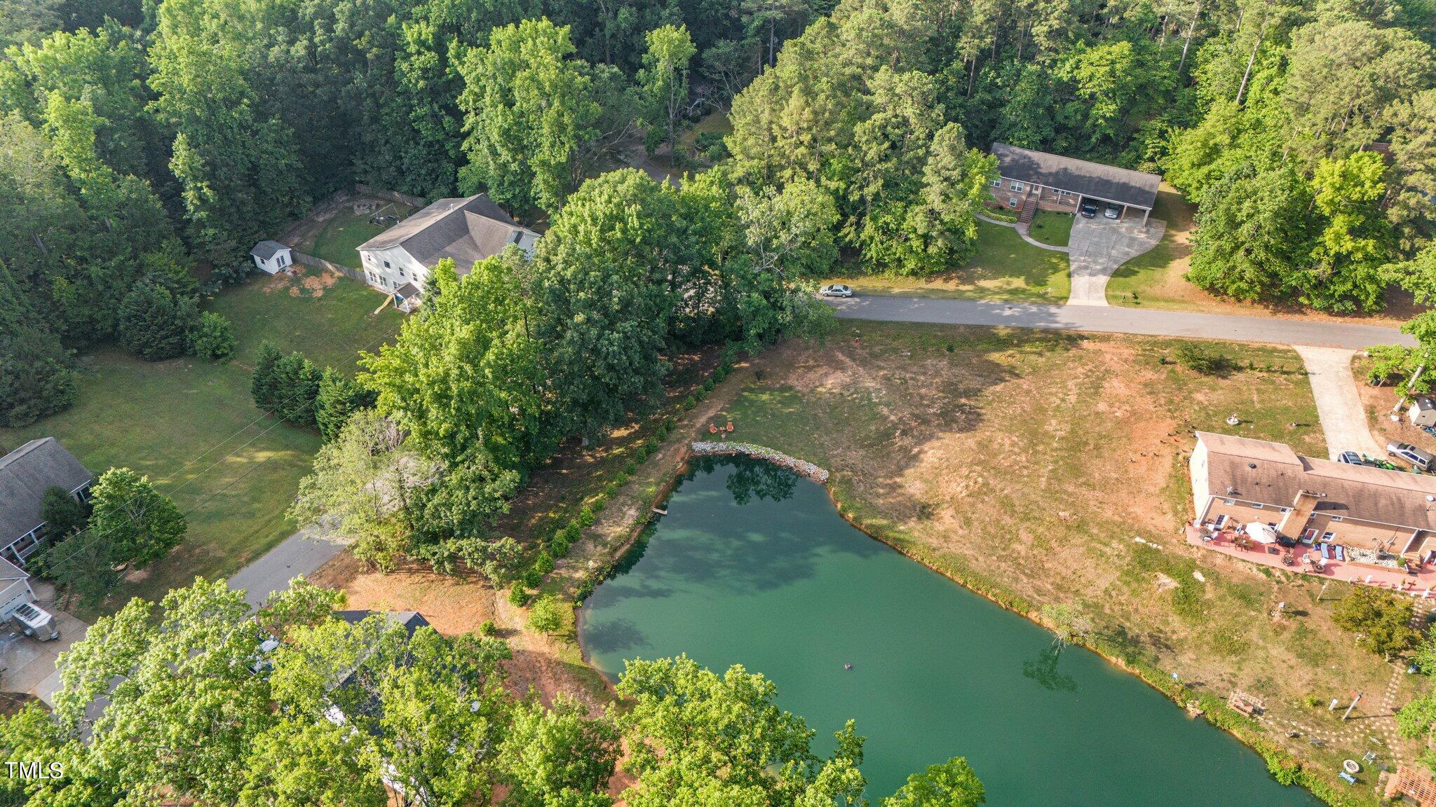 an aerial view of a house with a yard basket ball court and outdoor seating