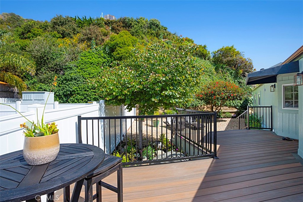 a view of balcony with wooden floor and seating space