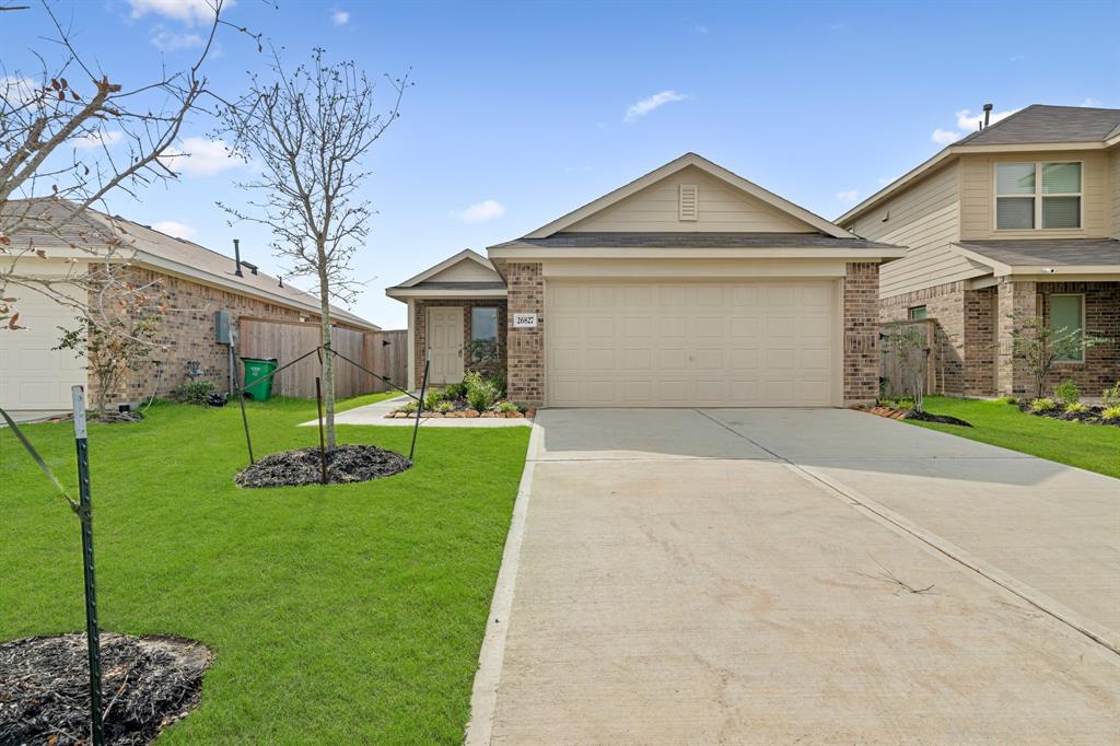 a front view of a house with a garden and yard