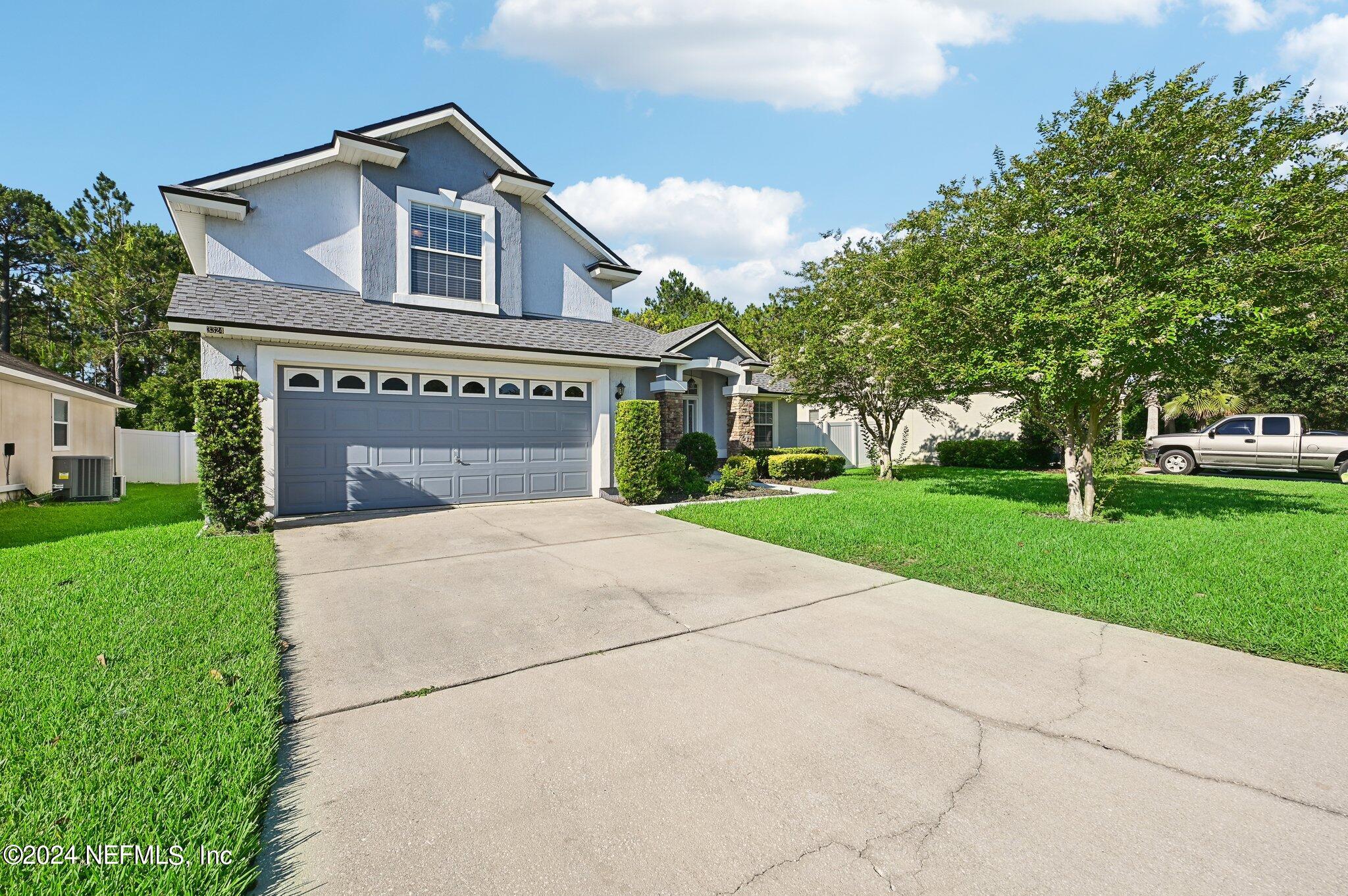 a front view of a house with a yard