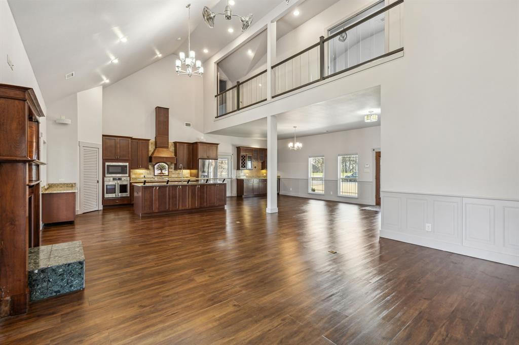 a view of a living room and kitchen with furniture wooden floor and a kitchen view