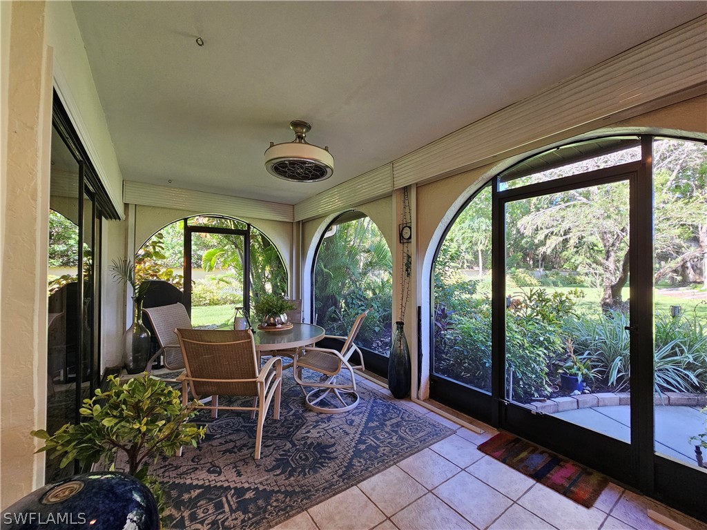 a view of a porch with chairs and backyard