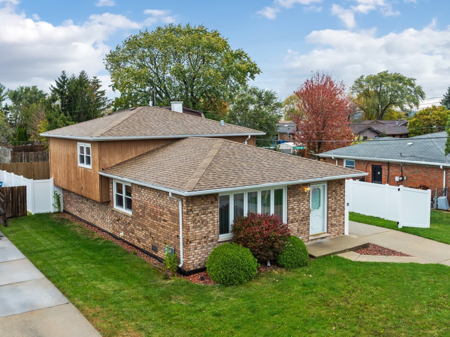 a aerial view of a house with a yard table and chairs