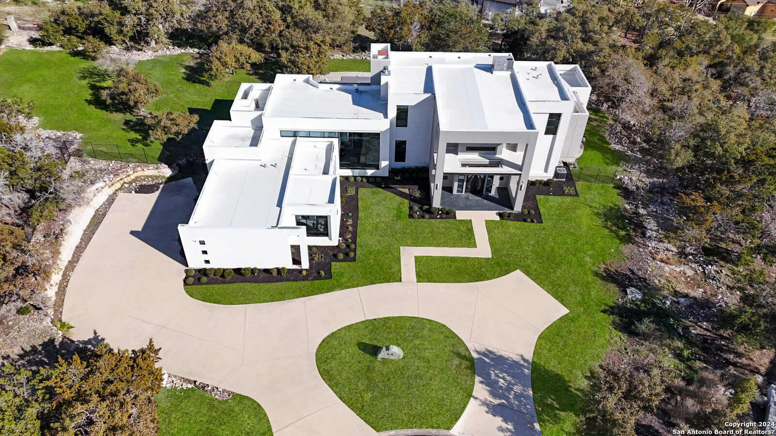 an aerial view of a house with swimming pool and porch