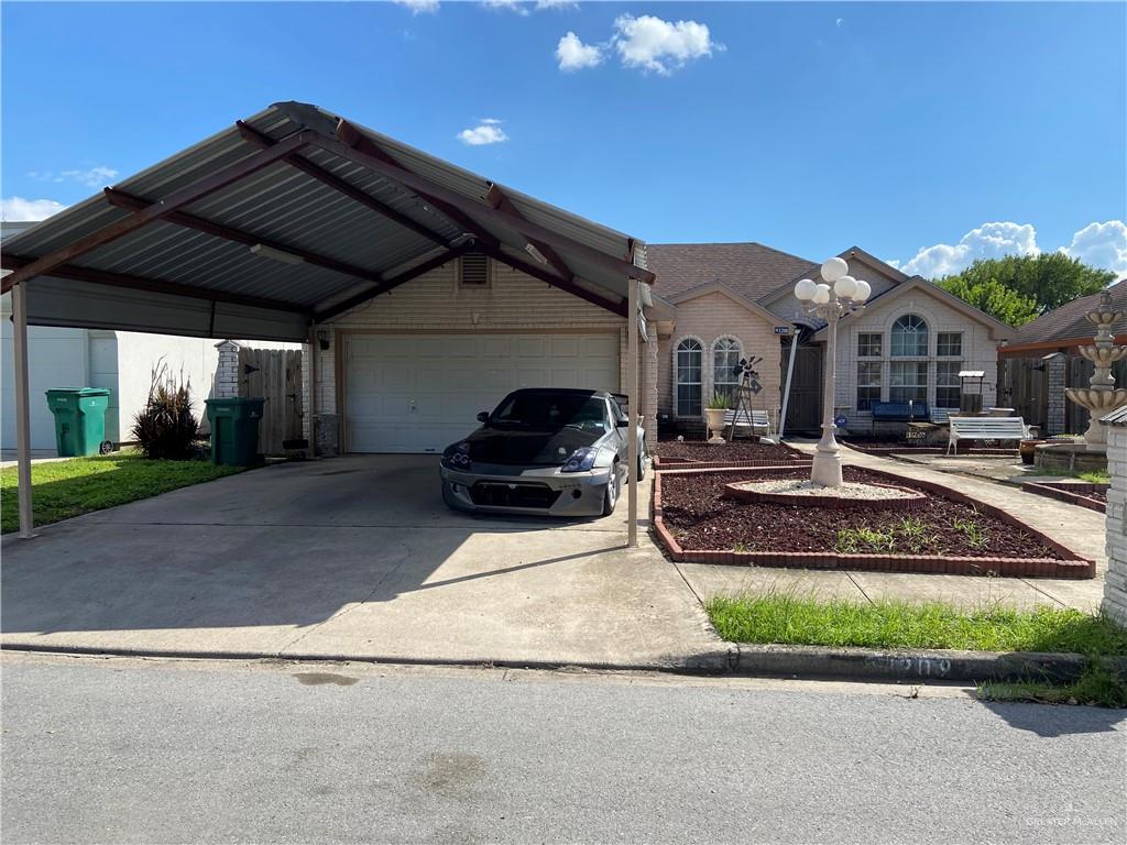 View of front of house featuring a carport and a garage