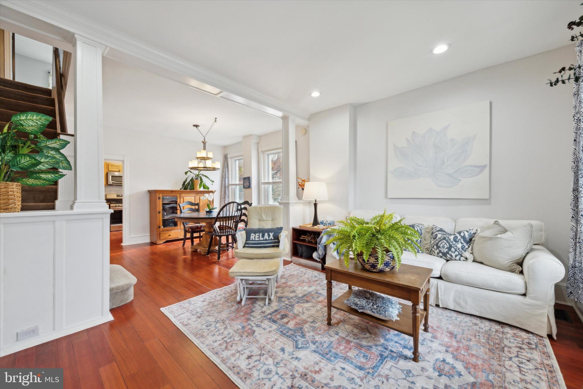 a living room with furniture and wooden floor