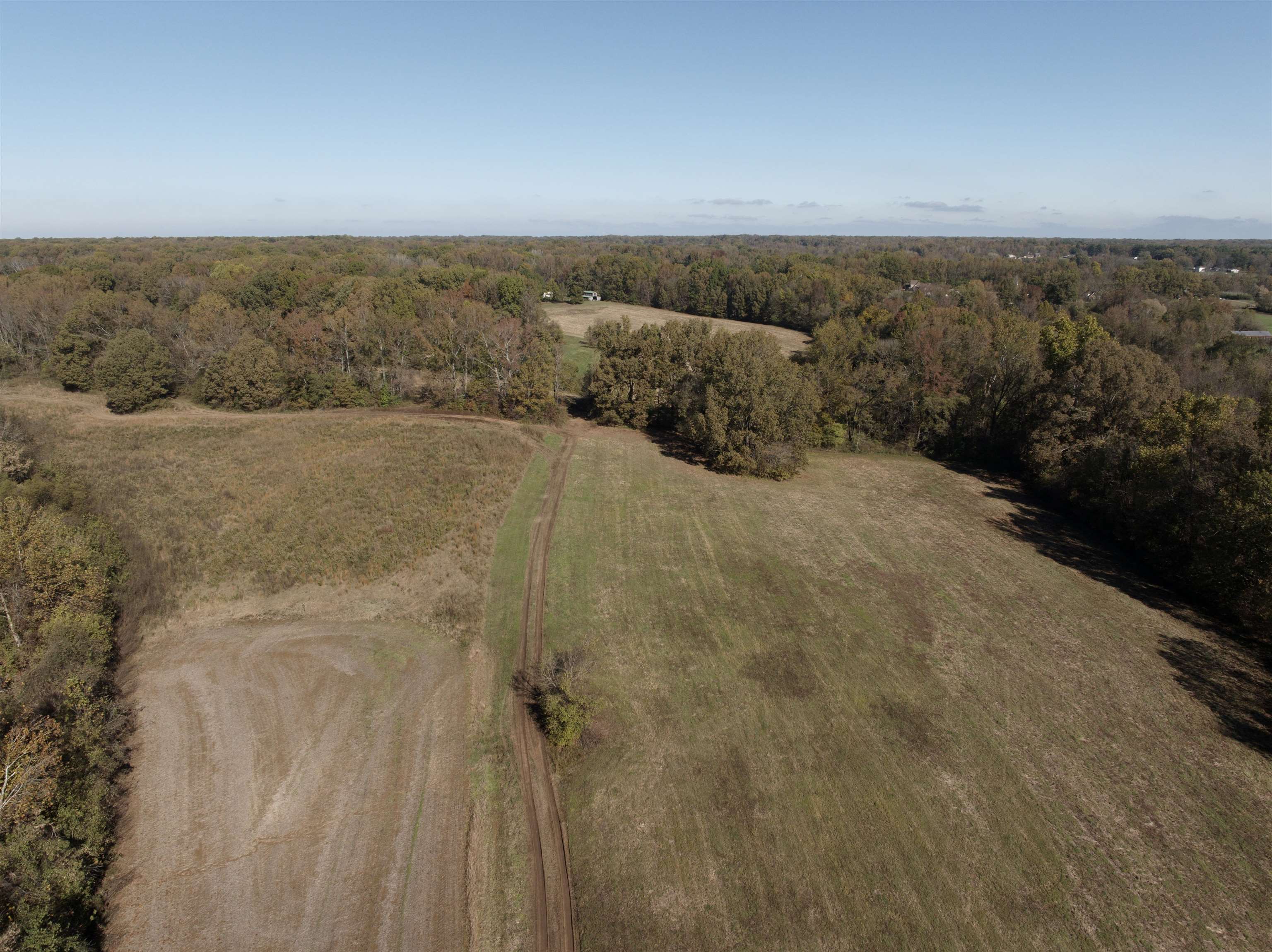 Drone / aerial view featuring a rural view. Parcel is to the right of the "Road" in the middle of the pic