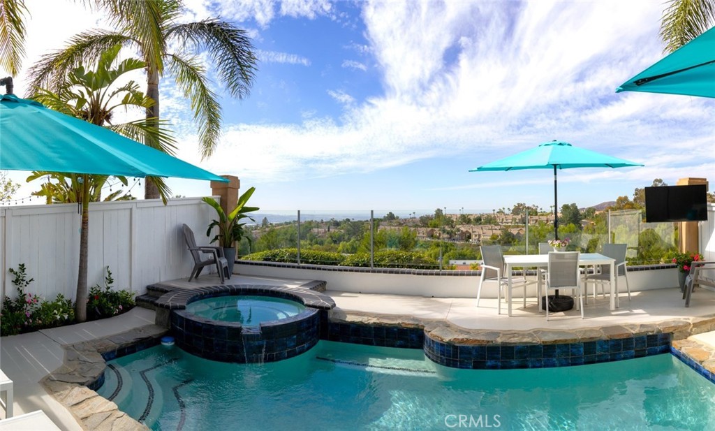 a swimming pool with outdoor seating and barbeque oven