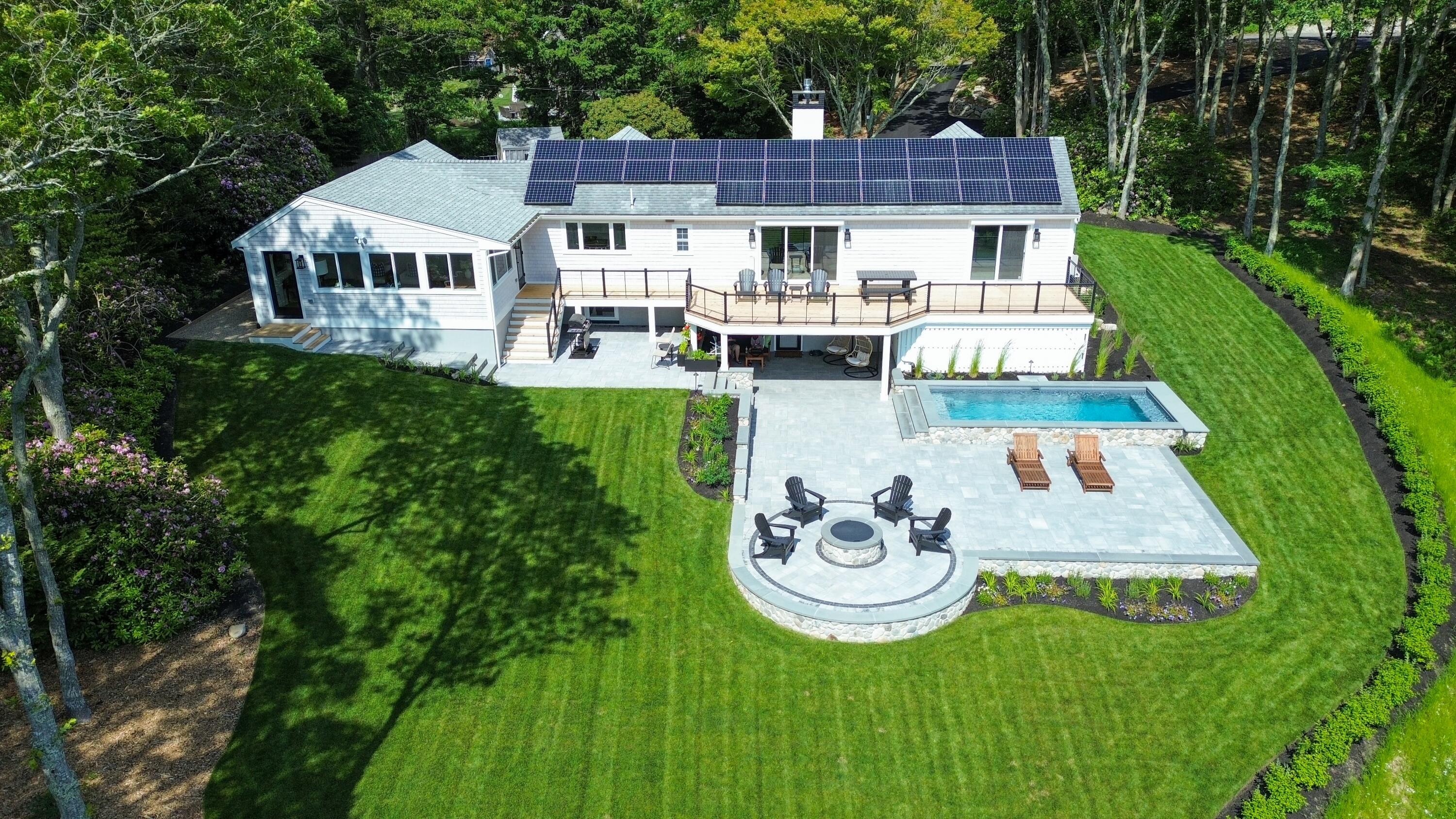 a view of a house with backyard and patio