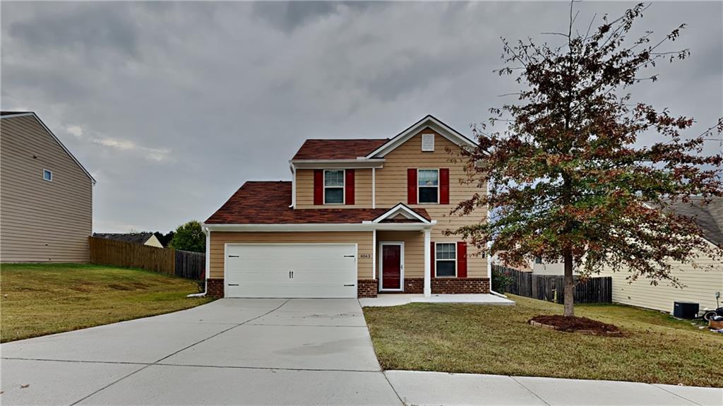 a front view of a house with a yard