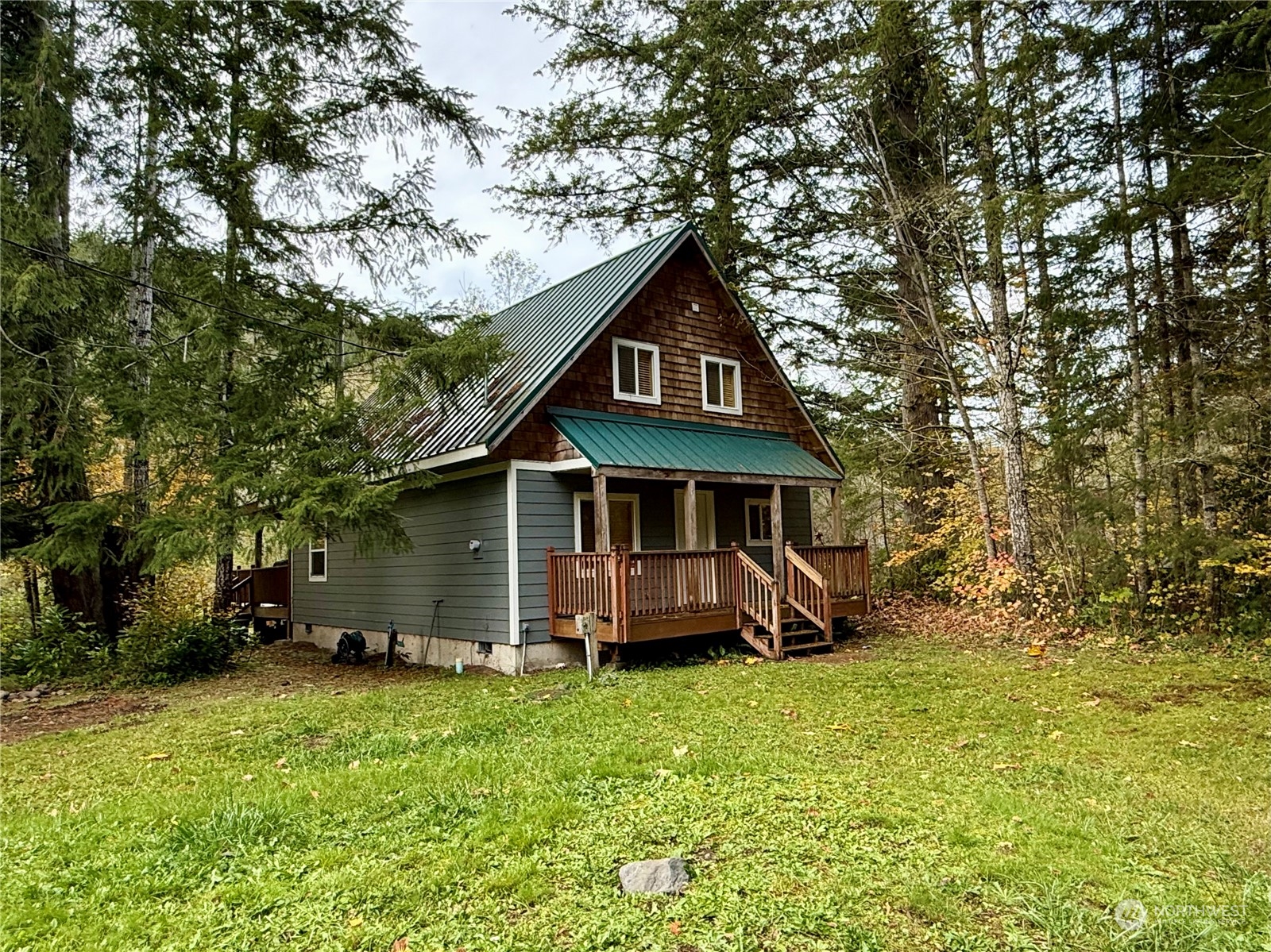 a view of a house with a yard and sitting area