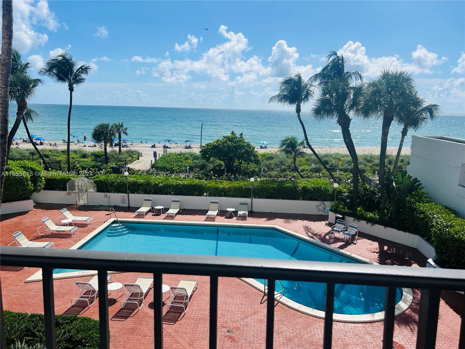 a view of swimming pool and lounge chairs