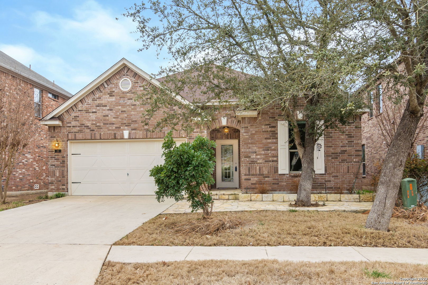 a front view of a house with a yard and garage