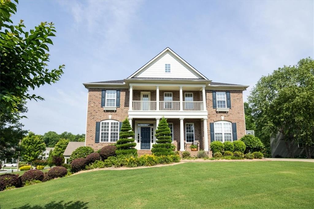 a front view of a house with a yard