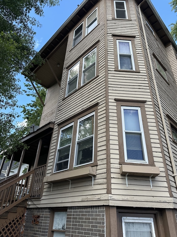 a view of a house with more windows and deck