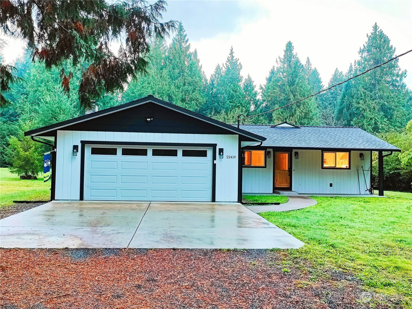 a front view of a house with a yard and garage