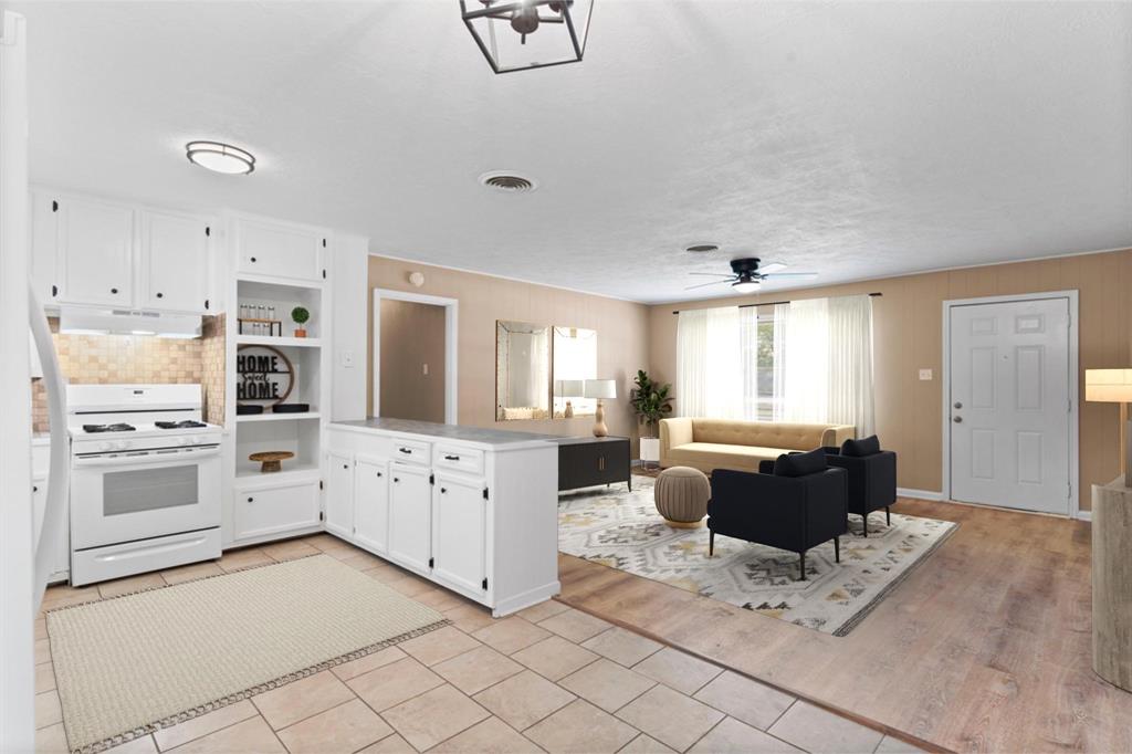 a living room with furniture and a kitchen