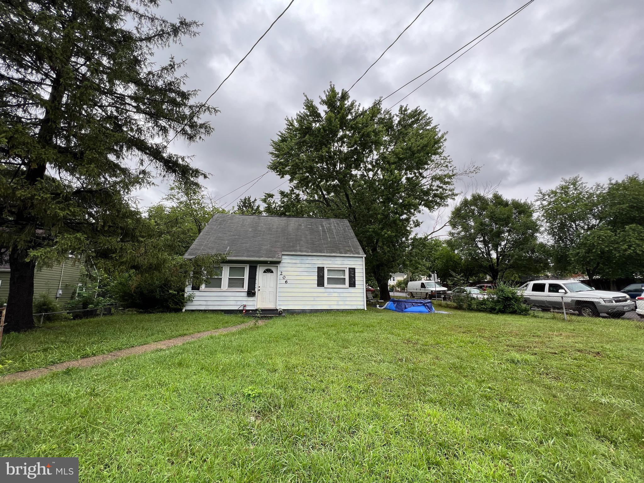 a view of a house with a big yard and large trees