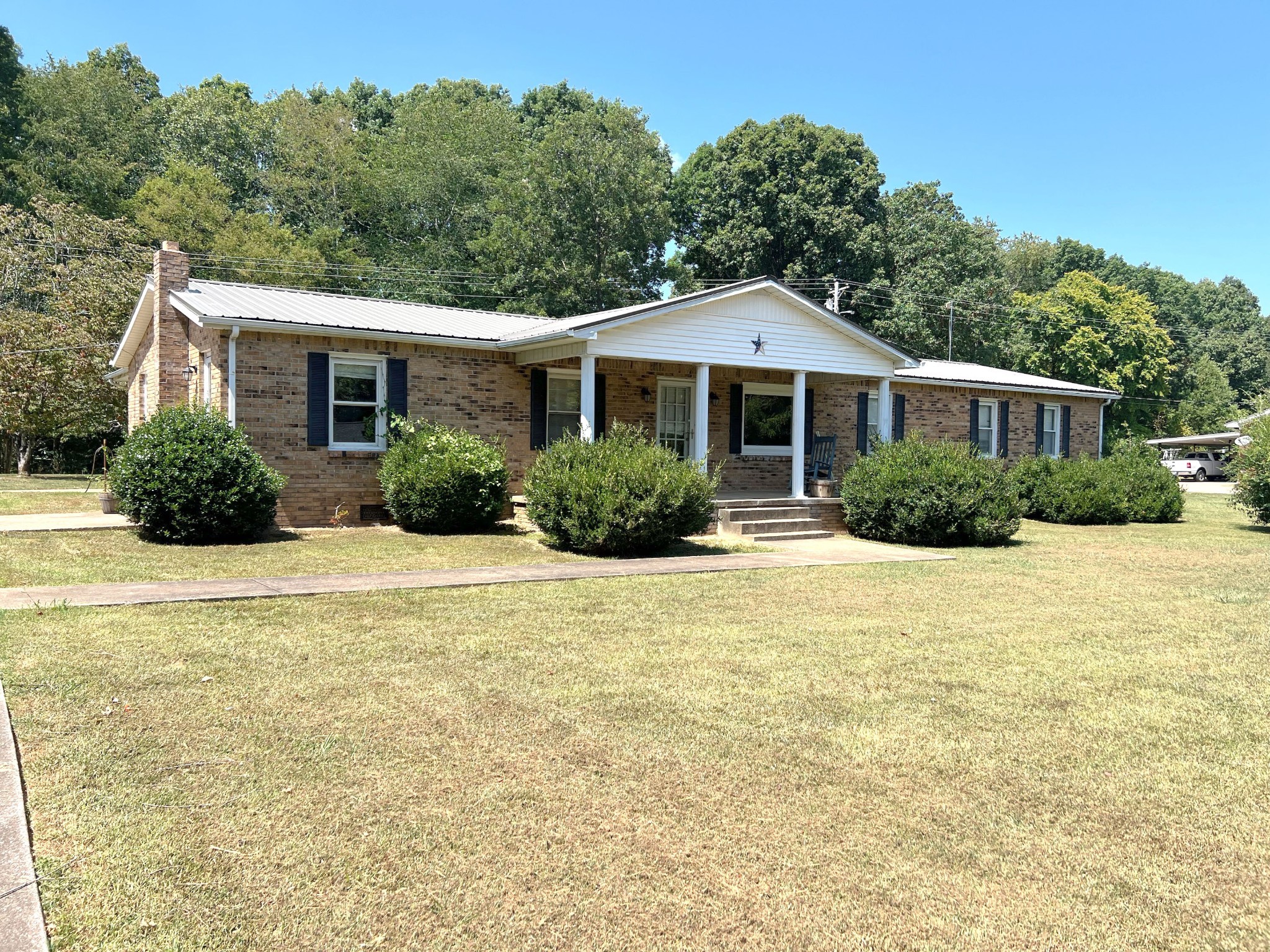 a front view of a house with yard and green space