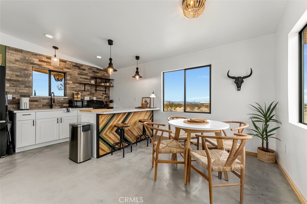 a kitchen with a table and chairs