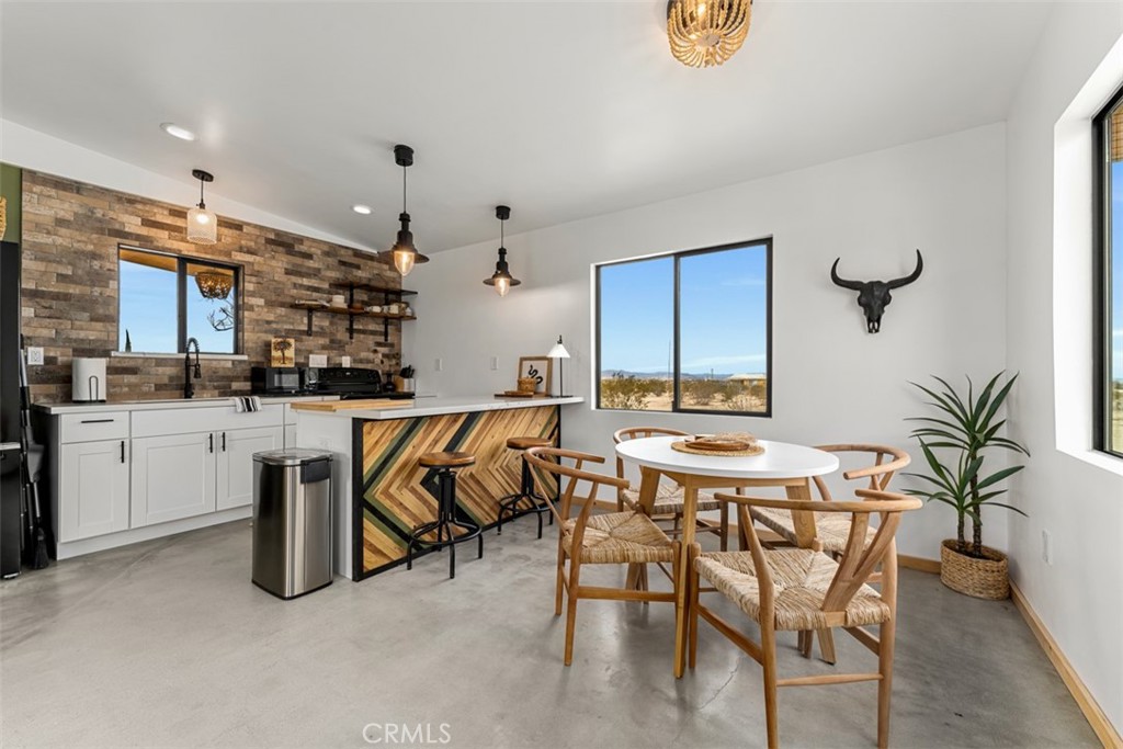 a kitchen with a table and chairs