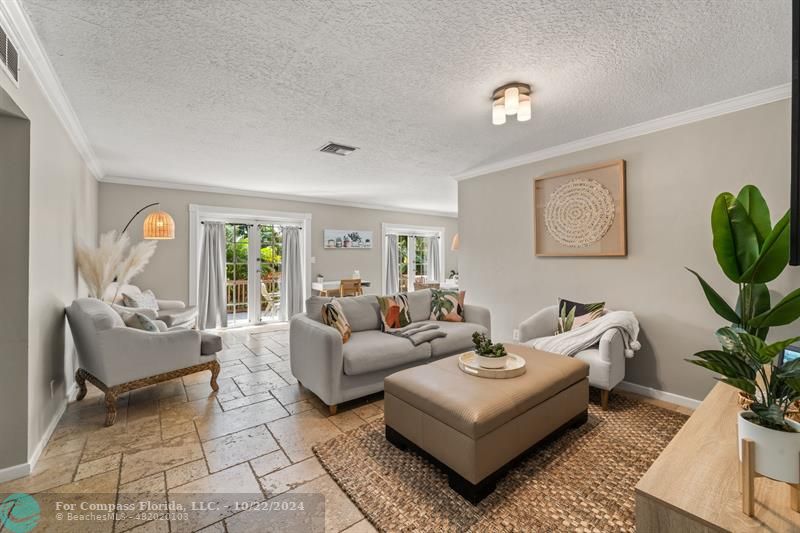 a living room with furniture and a potted plant