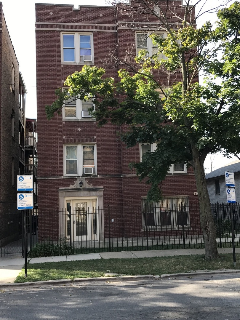 a view of a brick house with a yard