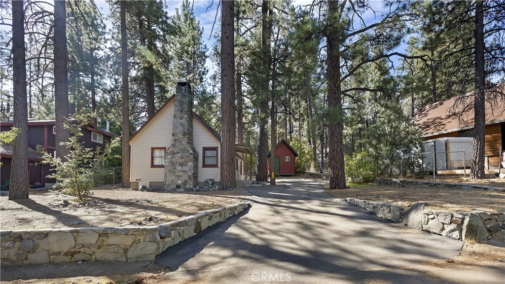 a front view of a house with trees