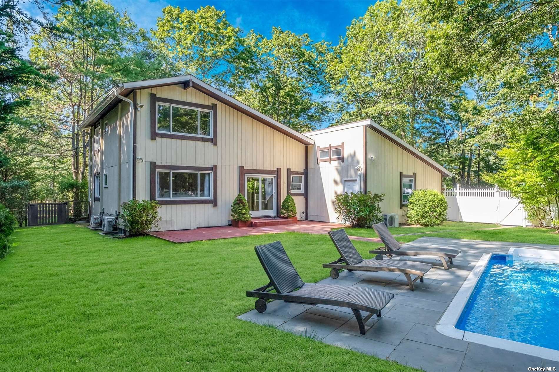 a view of a house with backyard sitting area and garden