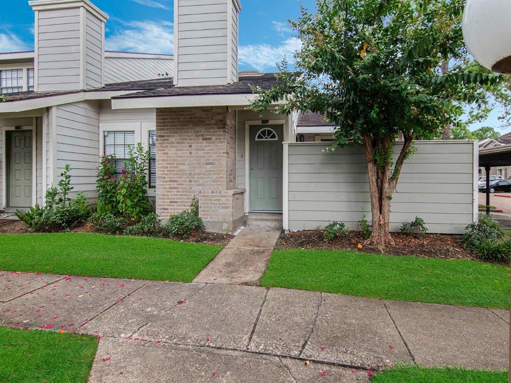 a front view of a house with a yard and a garage