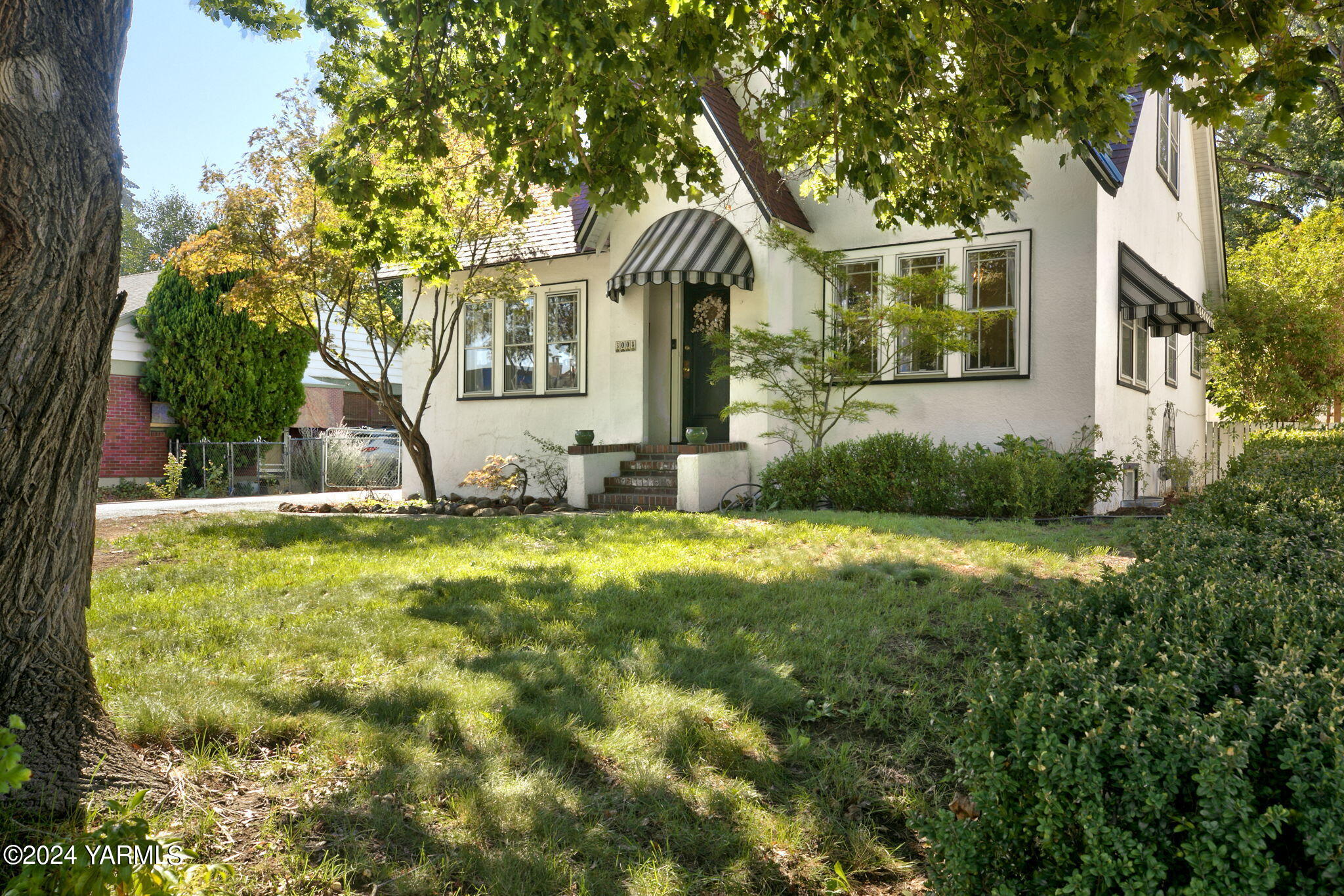 a front view of a house with garden