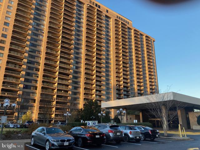 a front view of a building and car parked