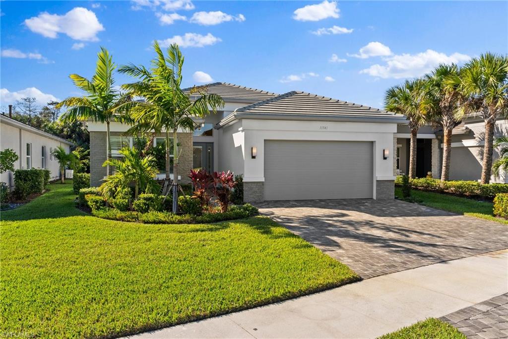 a front view of a house with a yard and garage