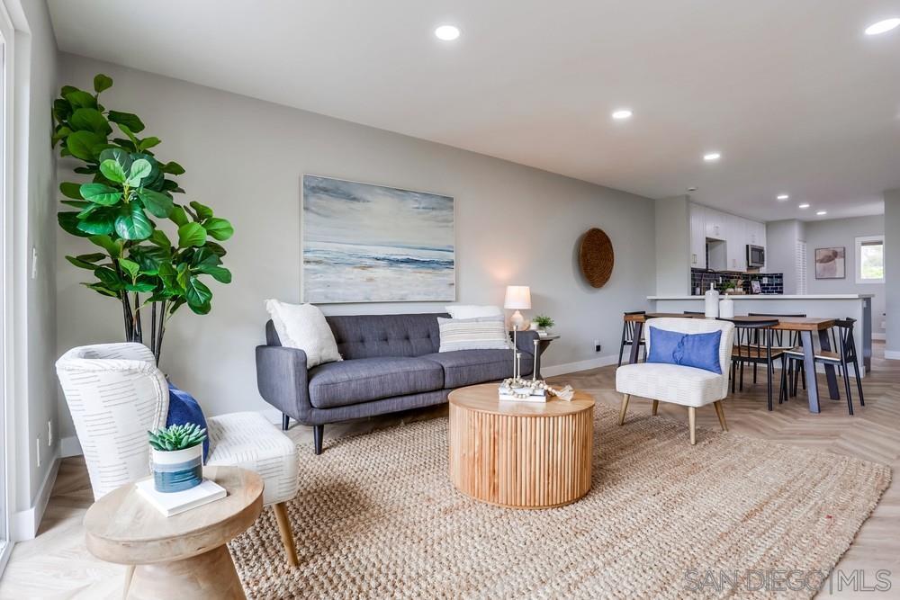 a living room with furniture and a potted plant