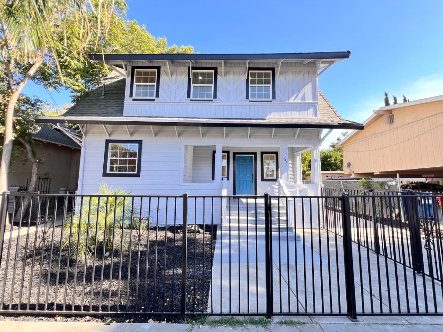 a view of a house with wooden fence