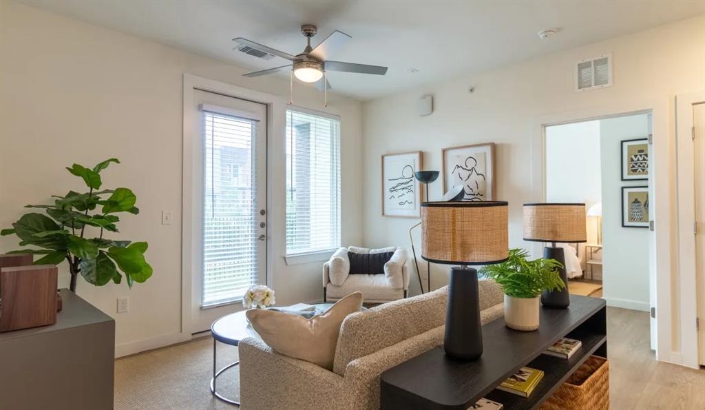 a living room with furniture and a potted plant