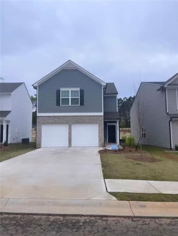 a front view of a house with a yard and garage