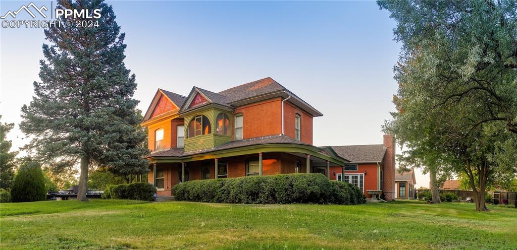 a front view of house with yard and green space